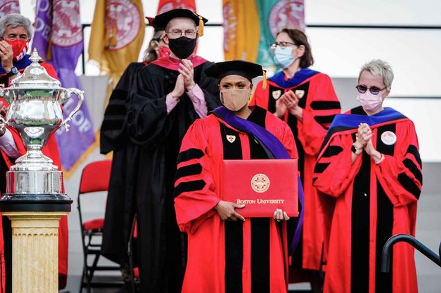 US Representative Ayanna Pressley holds the honorary degree awarded to her during the 2021 BU Commencement.