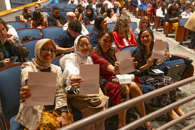 Students show off their programs at the Newbury Center Pinning Ceremony