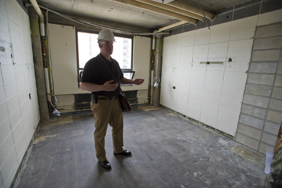 11-3795-SLEEPERFIX-001 Jeff Hoseth, associate director of construction services, in a gutted Sleeper Hall dorm room. Photo by Cydney Scott. Credit BU Today.