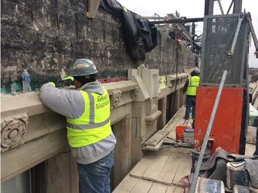 Rosettes and pilasters being installed at the east parapet.