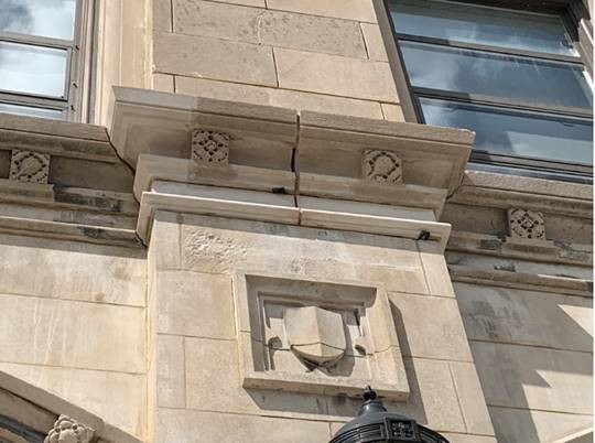 Limestone Capitals along Comm Ave being reinstalled.