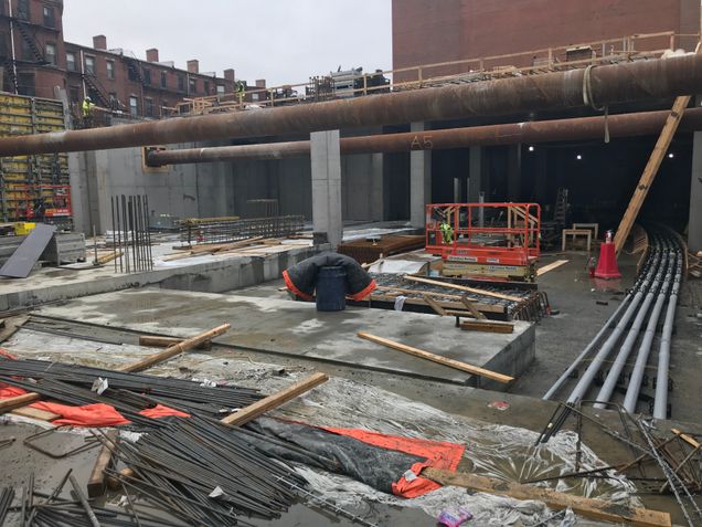 Concrete topping slab poured for the north half of the podium’s basement