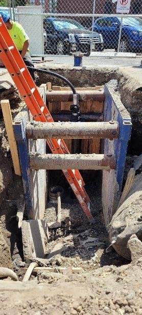 Installing geothermal piping into a well drilled during summer 2019