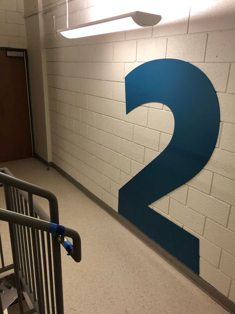 Placement of new floor-numbering graphics in the stairwells