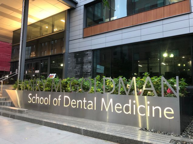 The Henry M. Goldman School of Dental Medicine sign with new lighting and plantings at the 635 Albany Street entrance