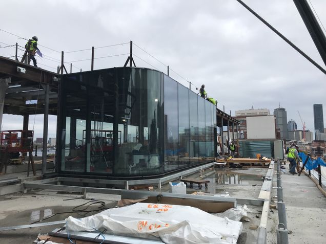 Installing curtain walls panels at the podium's 5th floor