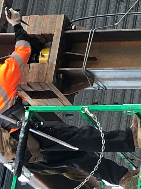 Crews jacking temporary shoring
