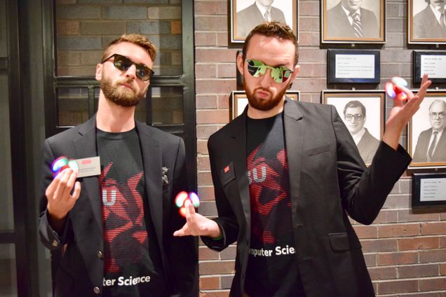 BUCS staff members Jacob Harrington (CAS/GRS’16) and Christian Cole (CAS’11) model CS Day’s popular giveaway: light-up fidget spinners. Photo by Laura Knipe.