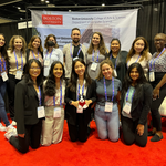 Boston University students pose in front of a Department of Computer Science banner at the Grace Hopper Celebration 2022.