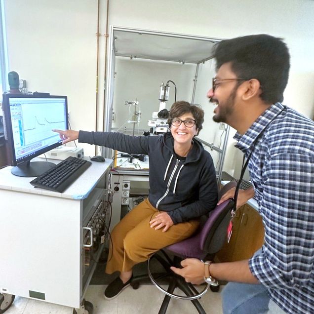 two people looking at a computer monitor