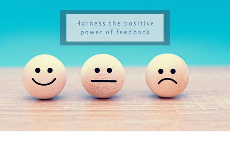 Positive power of feedback banner image with emojis reflecting happy, indifferent and sad emotions