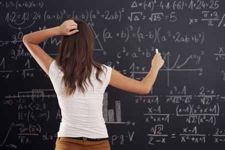 A student is working on several math problems on a chalkboard