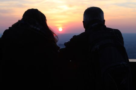 Sillouhette of a couple looking into the distance.