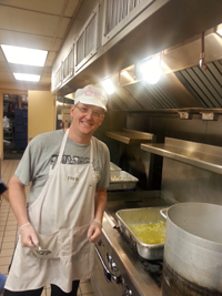 Group Practice Leader Dr. Francis Harrington tends the stove at Rosie’s Place