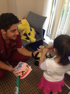 Faraz Tartibi DMD 16 sharing toys and education with a fairgoer