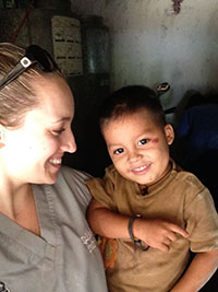 Kali Stewart DMD 15 spends time with a young visitor to the San Marcos clinic.