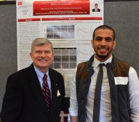 Dean Jeffrey W. Hutter with Khalid Alamoud and his poster