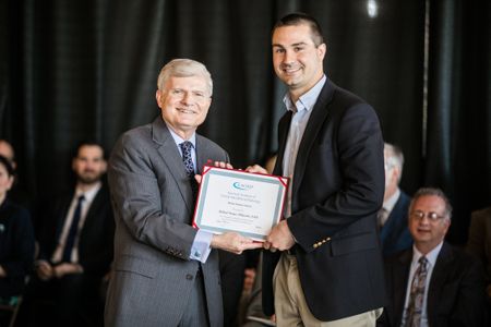 Dean Hutter presents an award to DMD Class of 2017 Valedictorian, Michael Whitcomb 