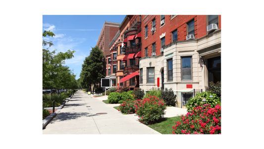 street scene in Boston. sidewalk with red brick buildings and stores on the right side