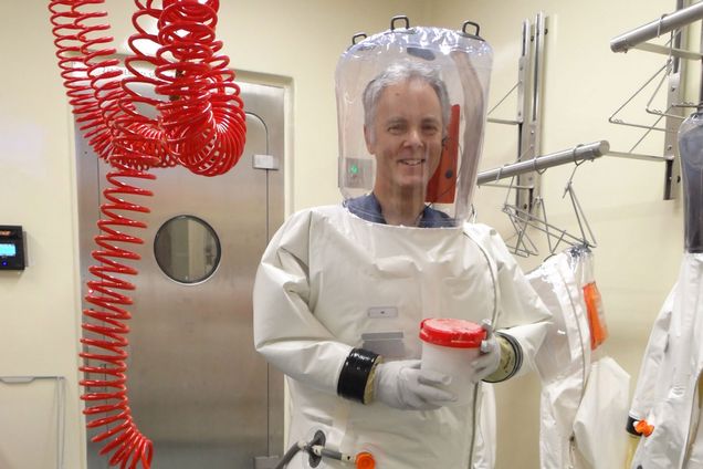BU microbiologist Robert Davey wearing a full containment suit while working with live SARS-Cov-2.