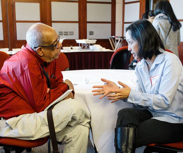 Male faculty member listening to a female associate at a Diversity event
