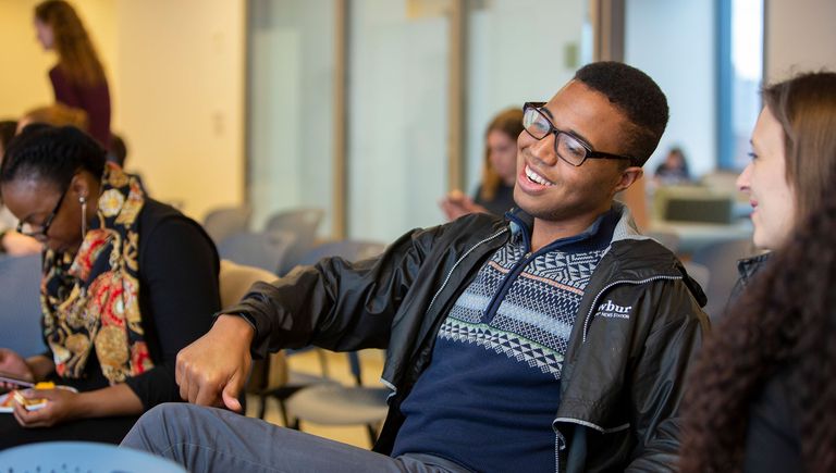 Two graduate students talking before their class begins