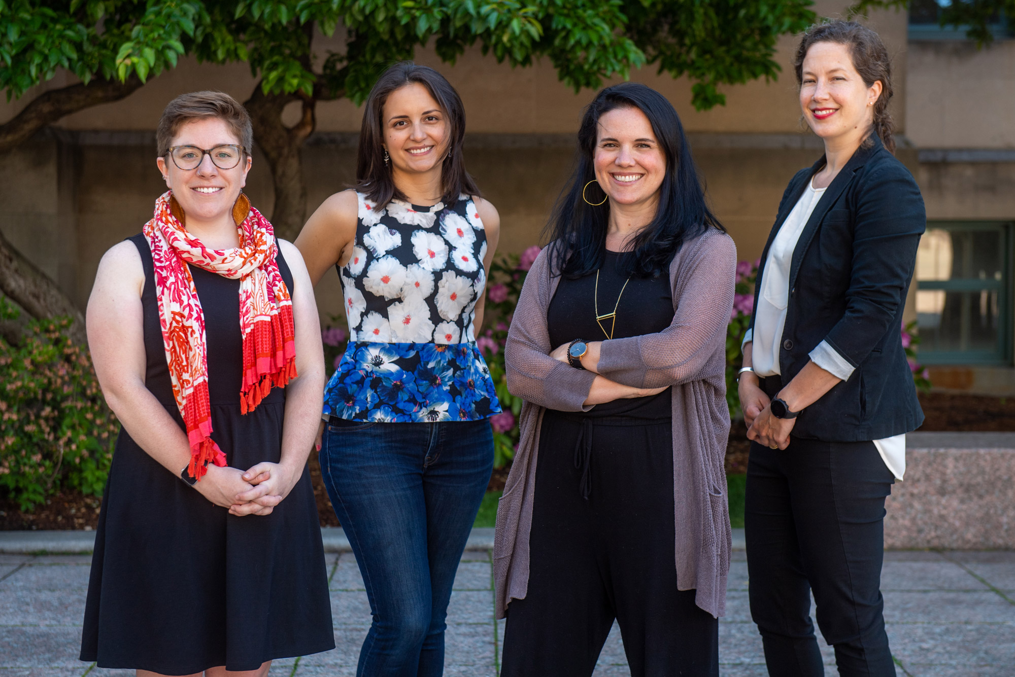 Four women pose for photo outdoors