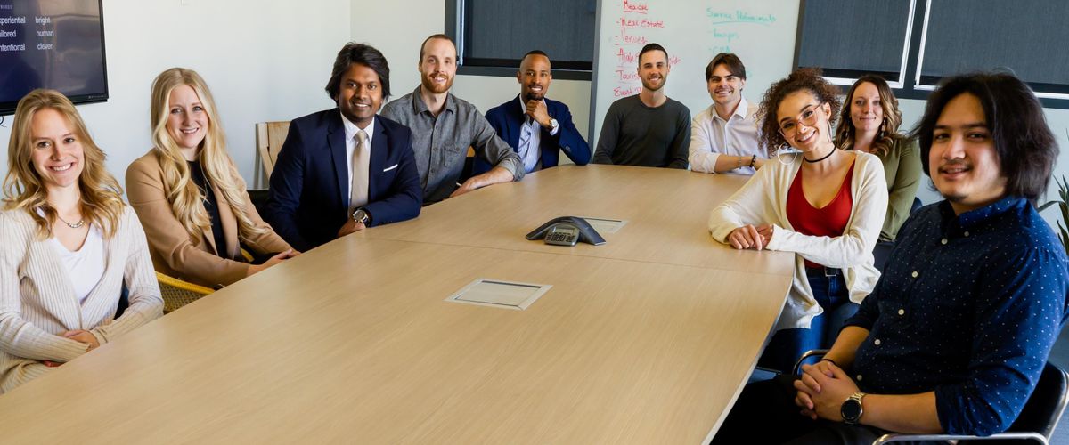 Diverse group of people seated around an office table