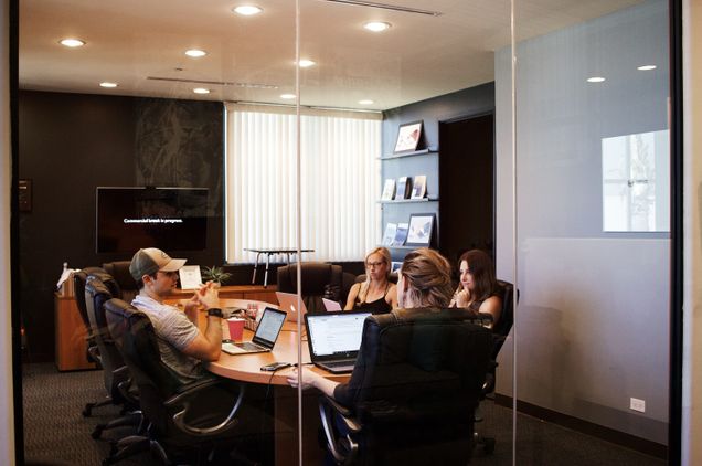 Conference table with four workers