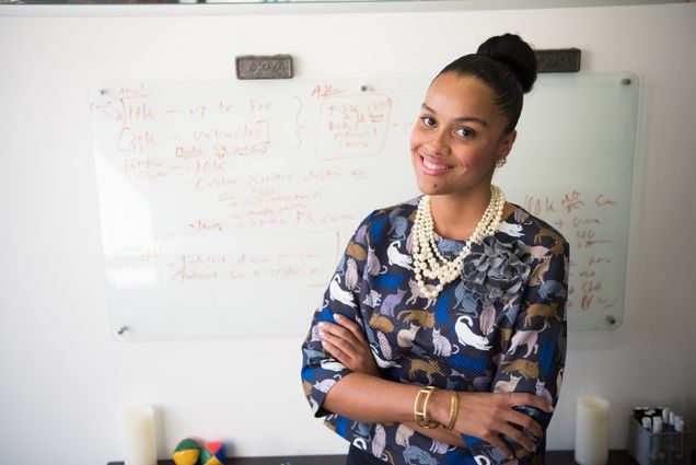 Black Woman standing in front of white board