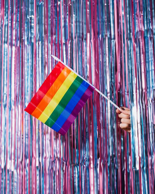 Streamers showing a hand holding a pride flag