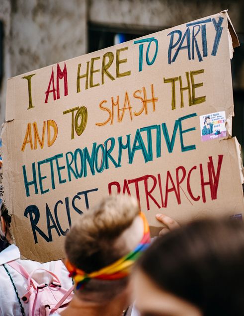 Sign of "I am here to party and to smash the heteronormative racist patriarchy"