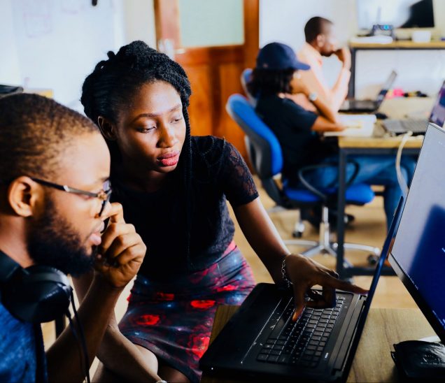Two black people working on something