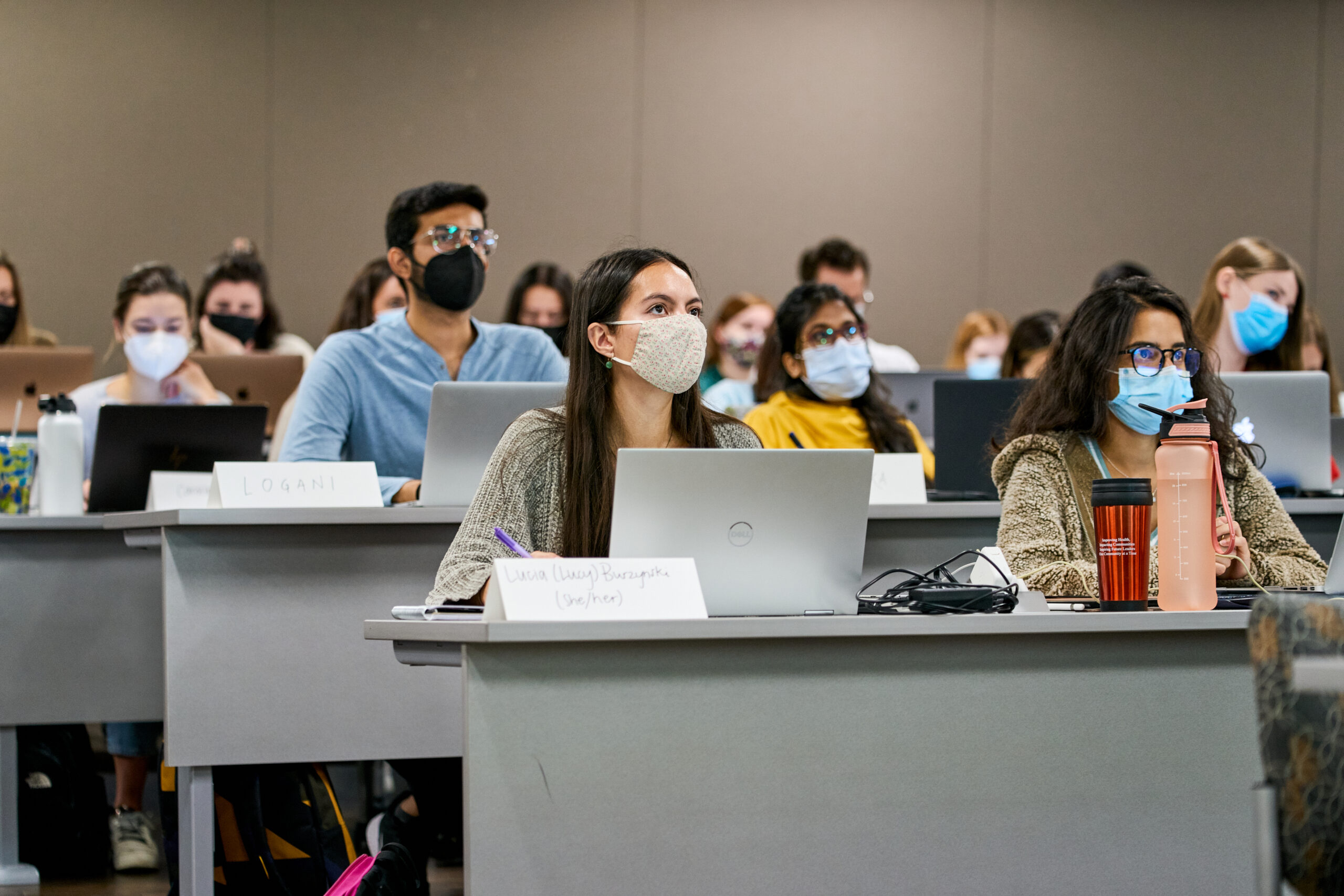 Students in class in masks with computers