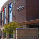 Image of BU's Agganis Arena outside and a sign for the John Hancock Student Village