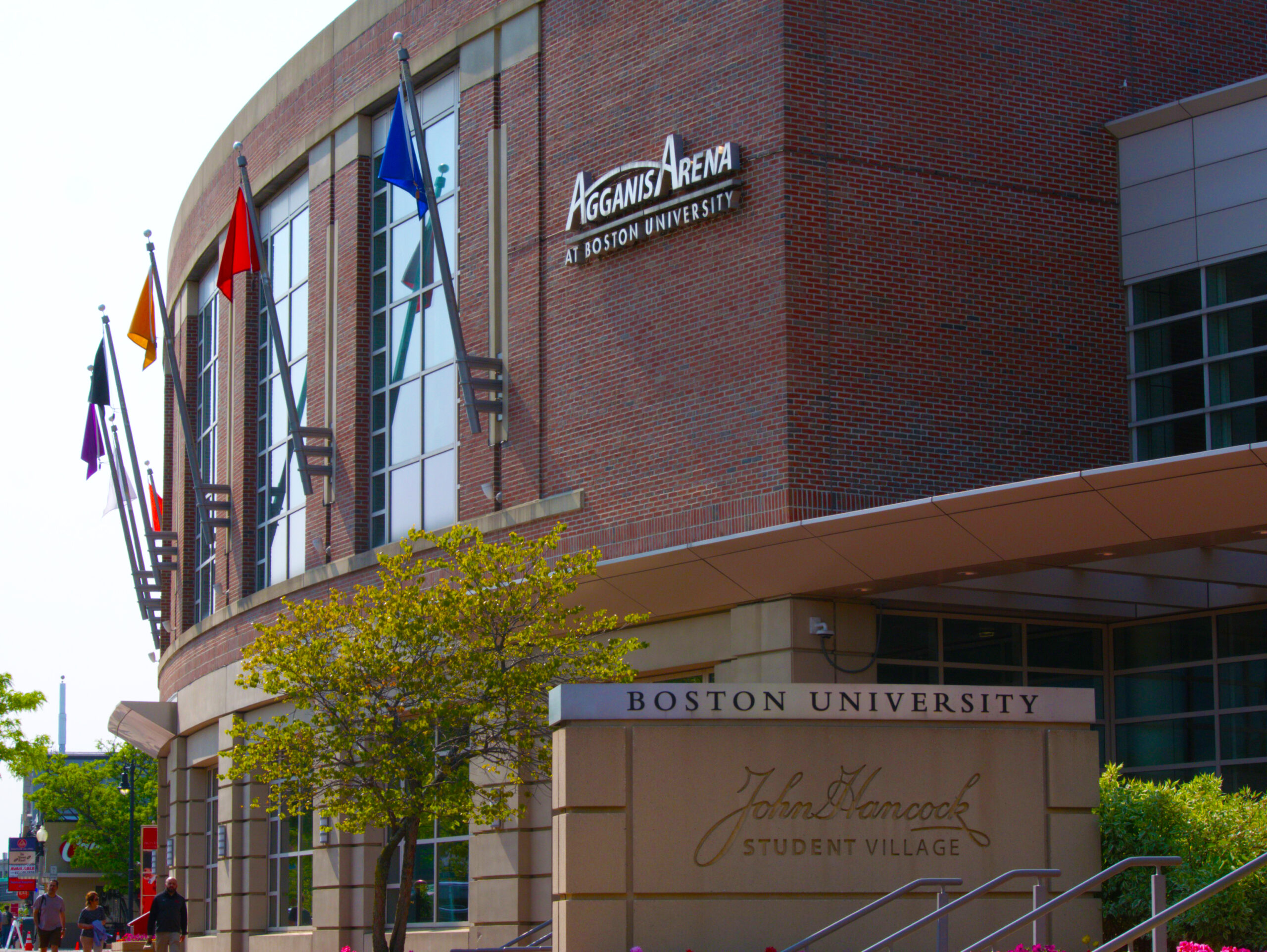 Image of BU's Agganis Arena outside and a sign for the John Hancock Student Village