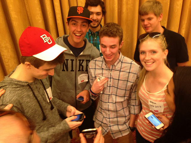 BU students using their smartphones to exchange contact information. Photo by Dean Elmore. 