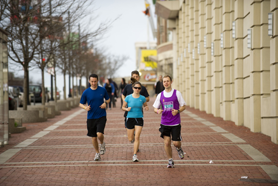 Three BU students train for the Boston Marathon along Commonwealth Avenue.