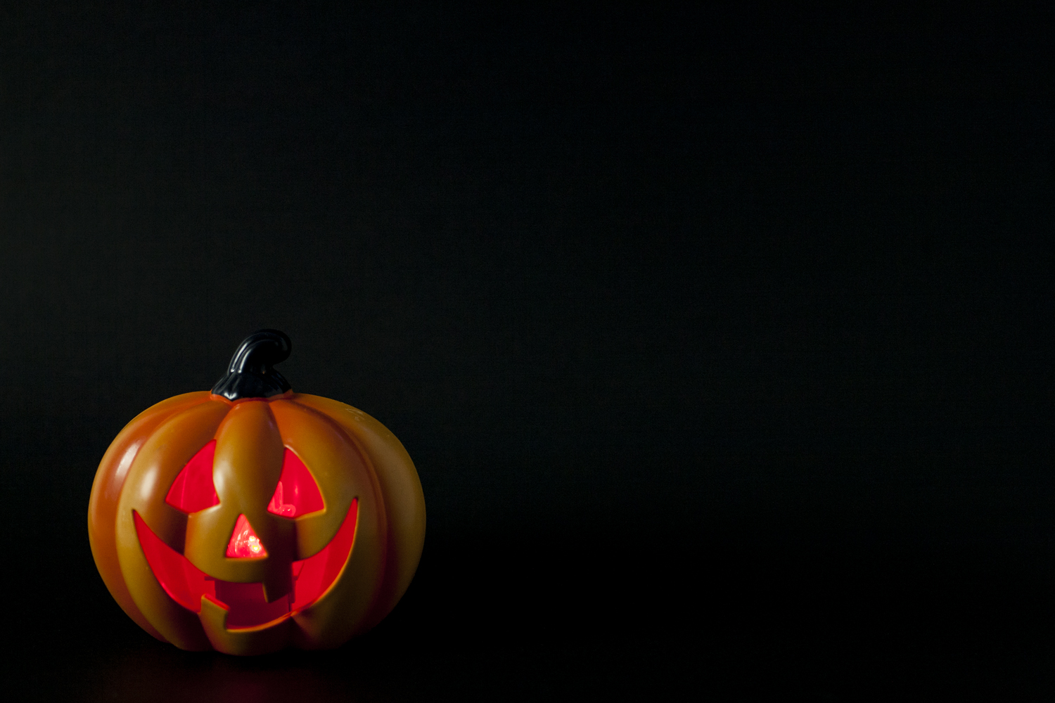 A Halloween pumpkin lit up 