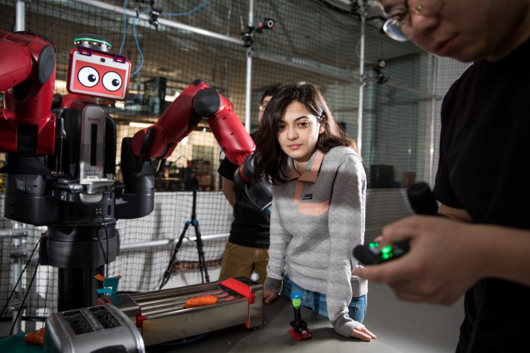 picture of a student in the robotics lab working on a robot