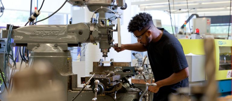 Student operating drill press