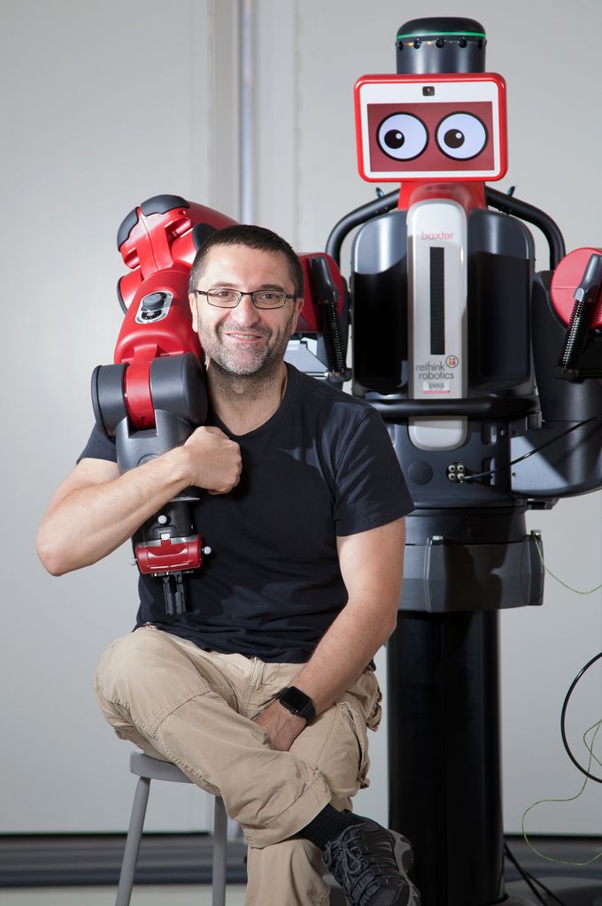 Professor Calin Belta (ME, SE, ECE) with Baxter robot at EPIC. Photo by Dana Smith for Boston University Photography