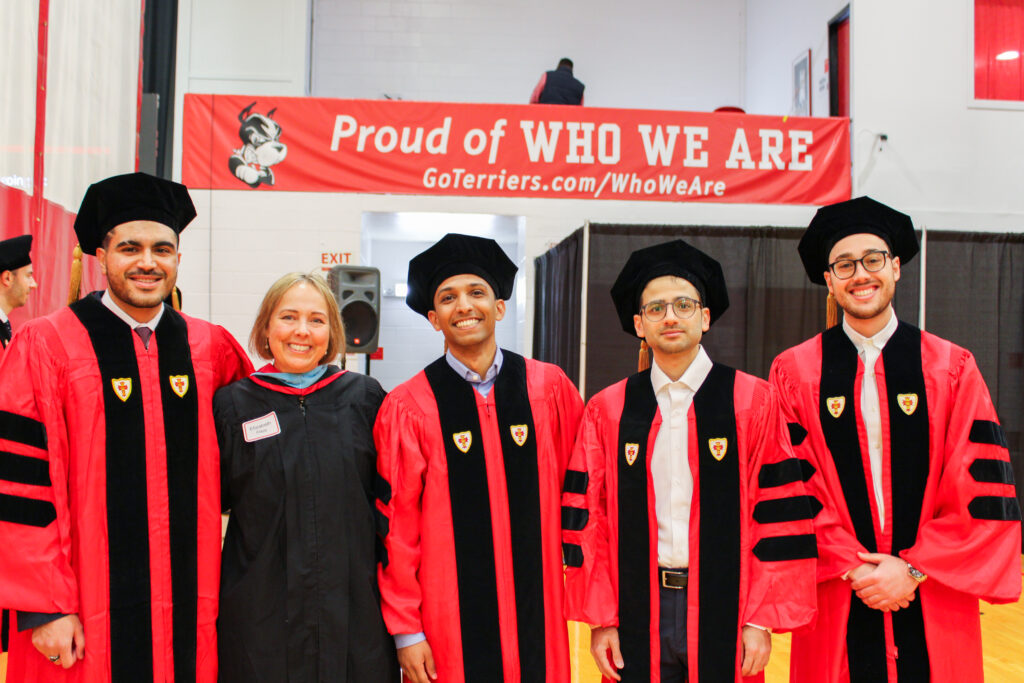 SE PhD graduates with smiles on their faces alongside the Divisions Director: Elizabeth Flagg
