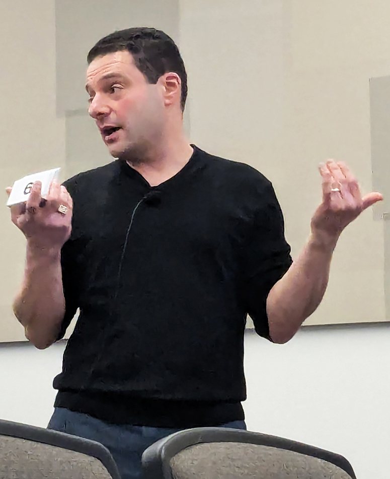 Professor Ed Solovey mid-explanation, gesturing with both hands.