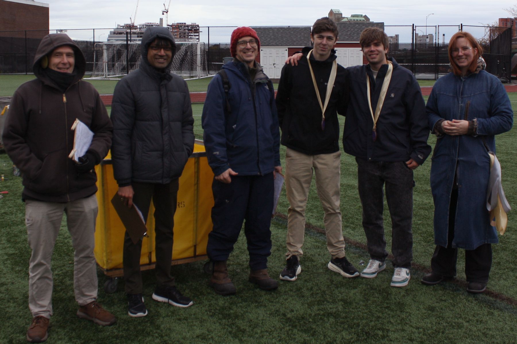 the 3 judges, the 2 first place students, and K in a line