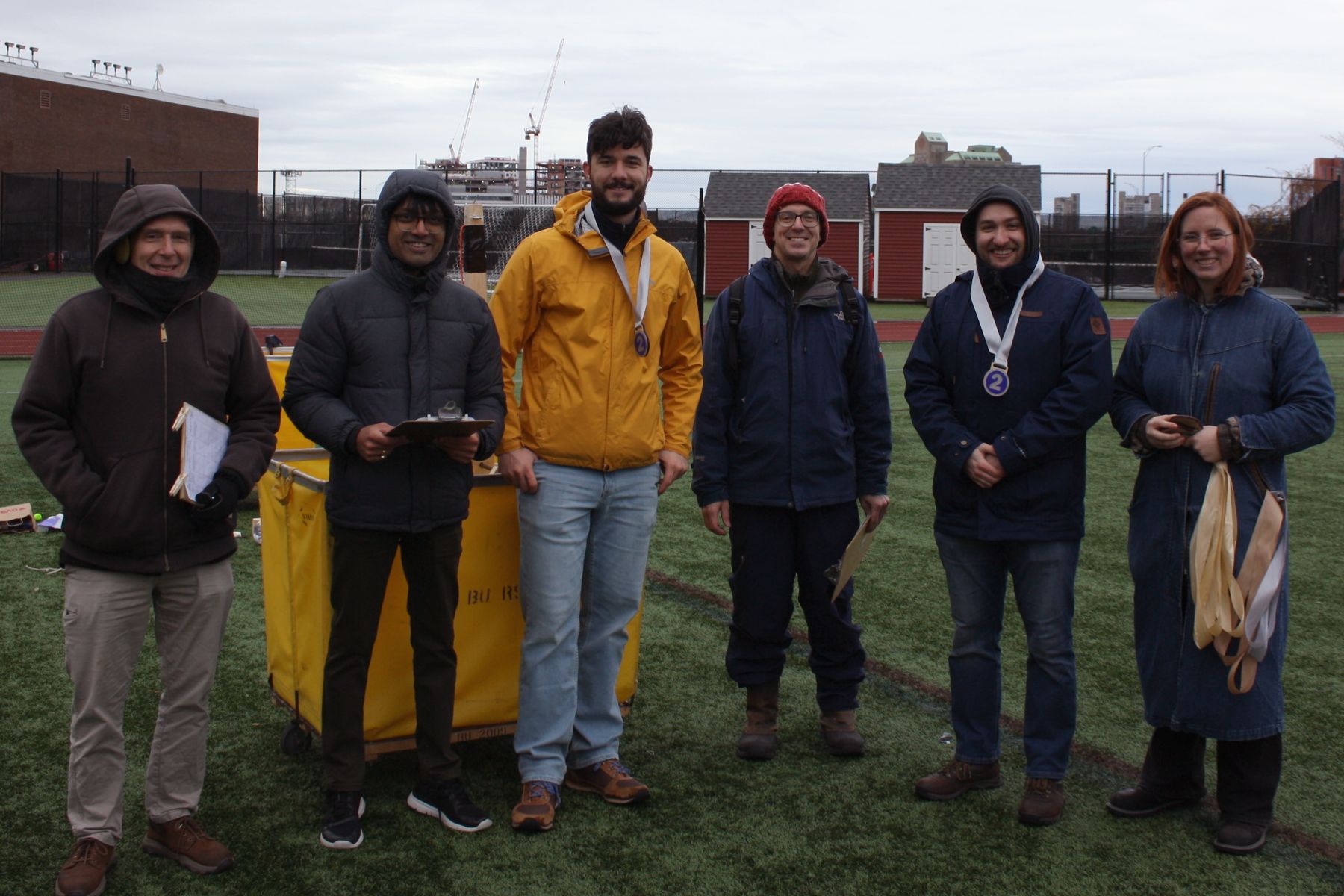 2 judges, 1 of the students, the 3rd judge, the 2nd student, and K all in a line