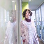 Ziba Cranmer smiling next to a whiteboard
