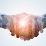 A double exposure image shows a handshake overlaying a cityscape and businesspeople silhouettes. The tone conveys collaboration and partnership.