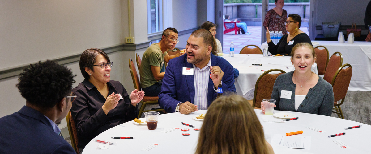 Faculty mingling at a reception
