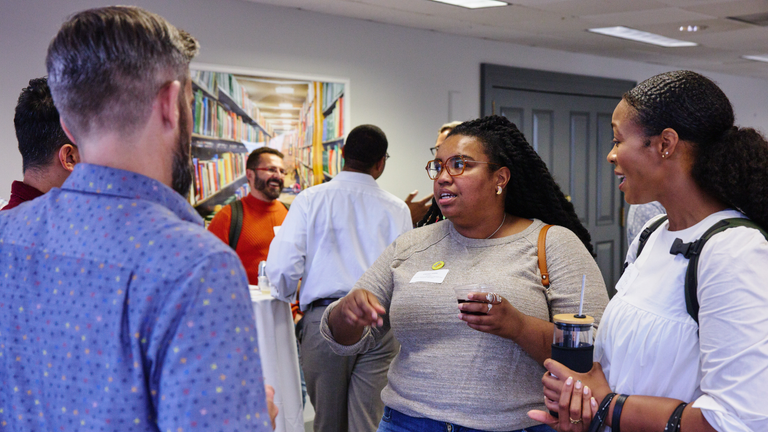 Faculty mingling at a reception